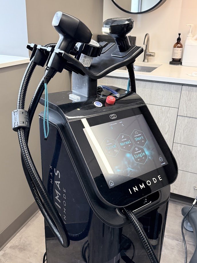 Close-up of the InMode OptimasMAX platform and its treatment handpieces at Refined
